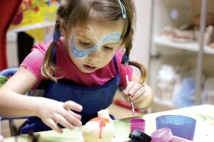 girl painting pottery
